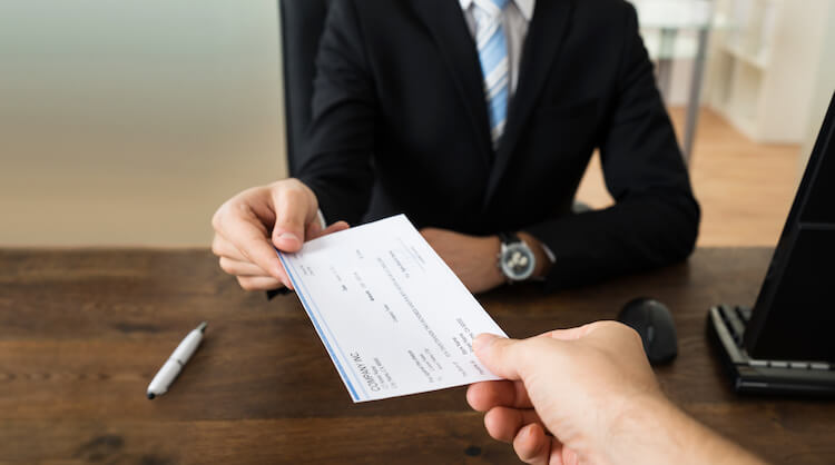 Business Person Giving Cheque To Other Person